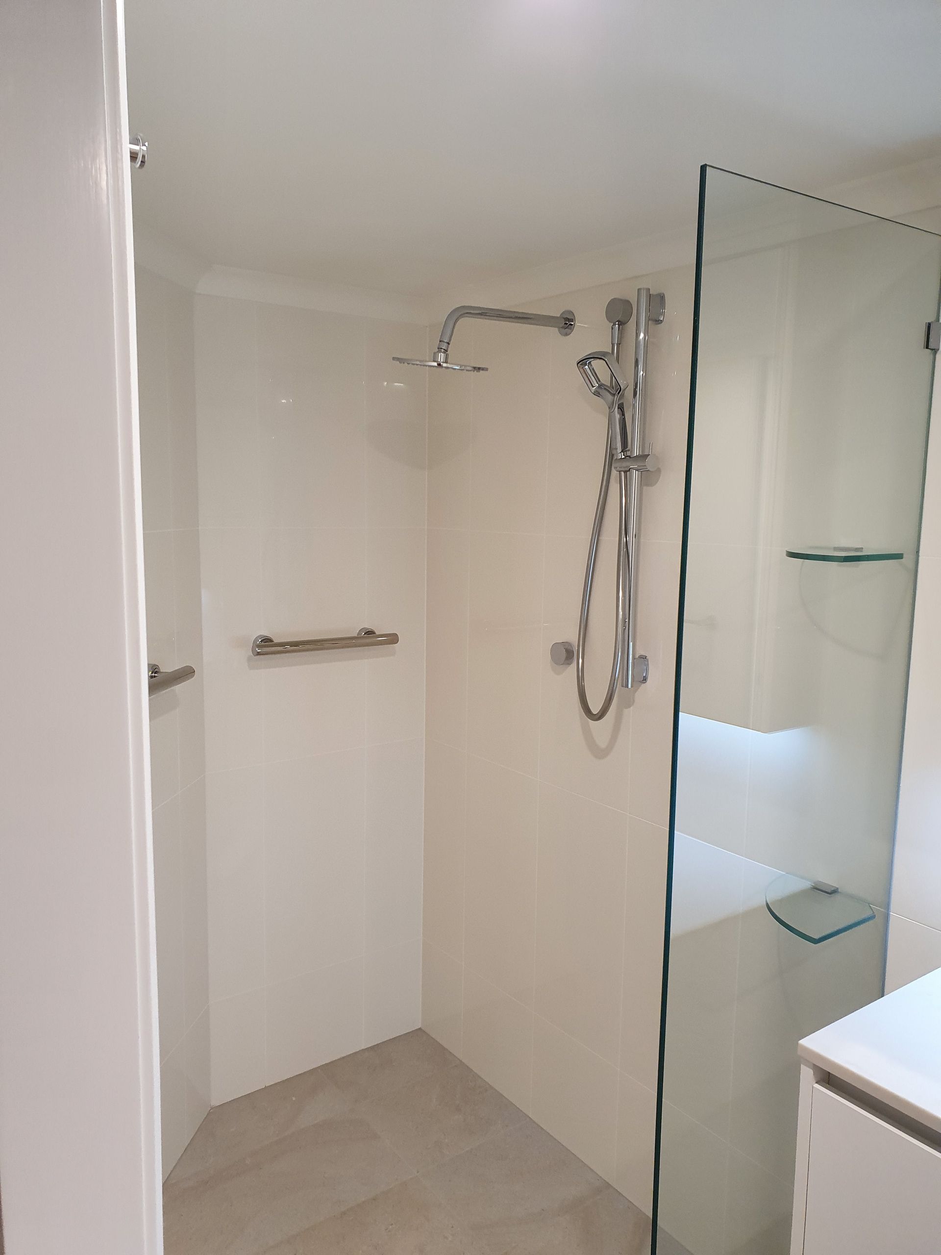 A Bathroom With a Walk in Shower and a Sin  — Scott Graham Building Services In Bilambil Heights, NSW 