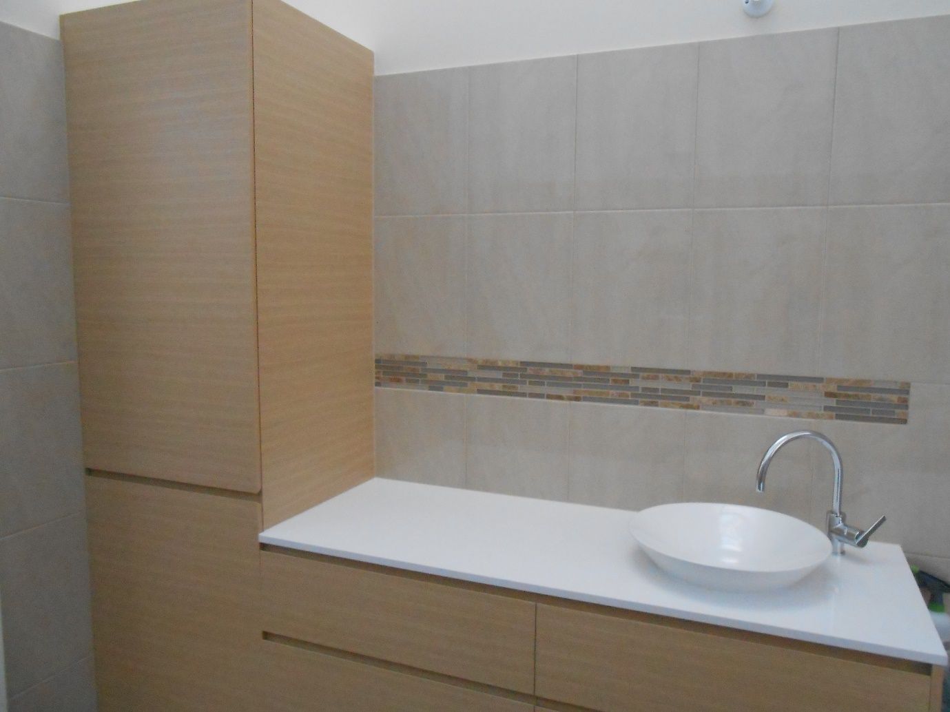 A Bathroom With a Sink and a Wooden Cabinet  — Scott Graham Building Services In Bilambil Heights, NSW 
