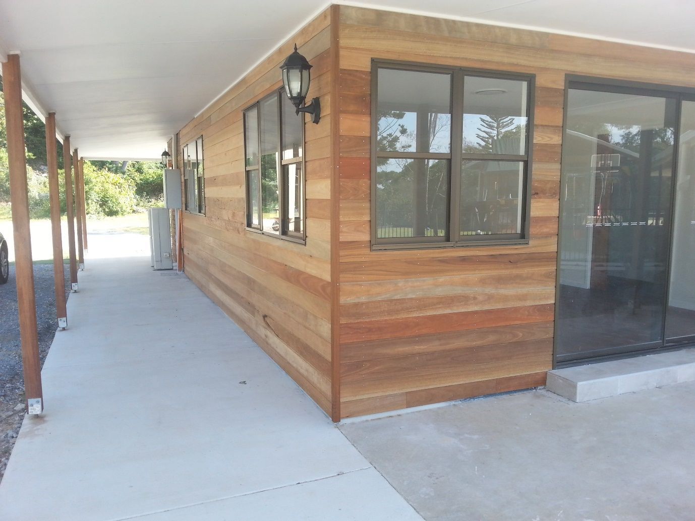 A House With Wood Paneling and Sliding Glass Doors  — Scott Graham Building Services In Bilambil Heights, NSW 