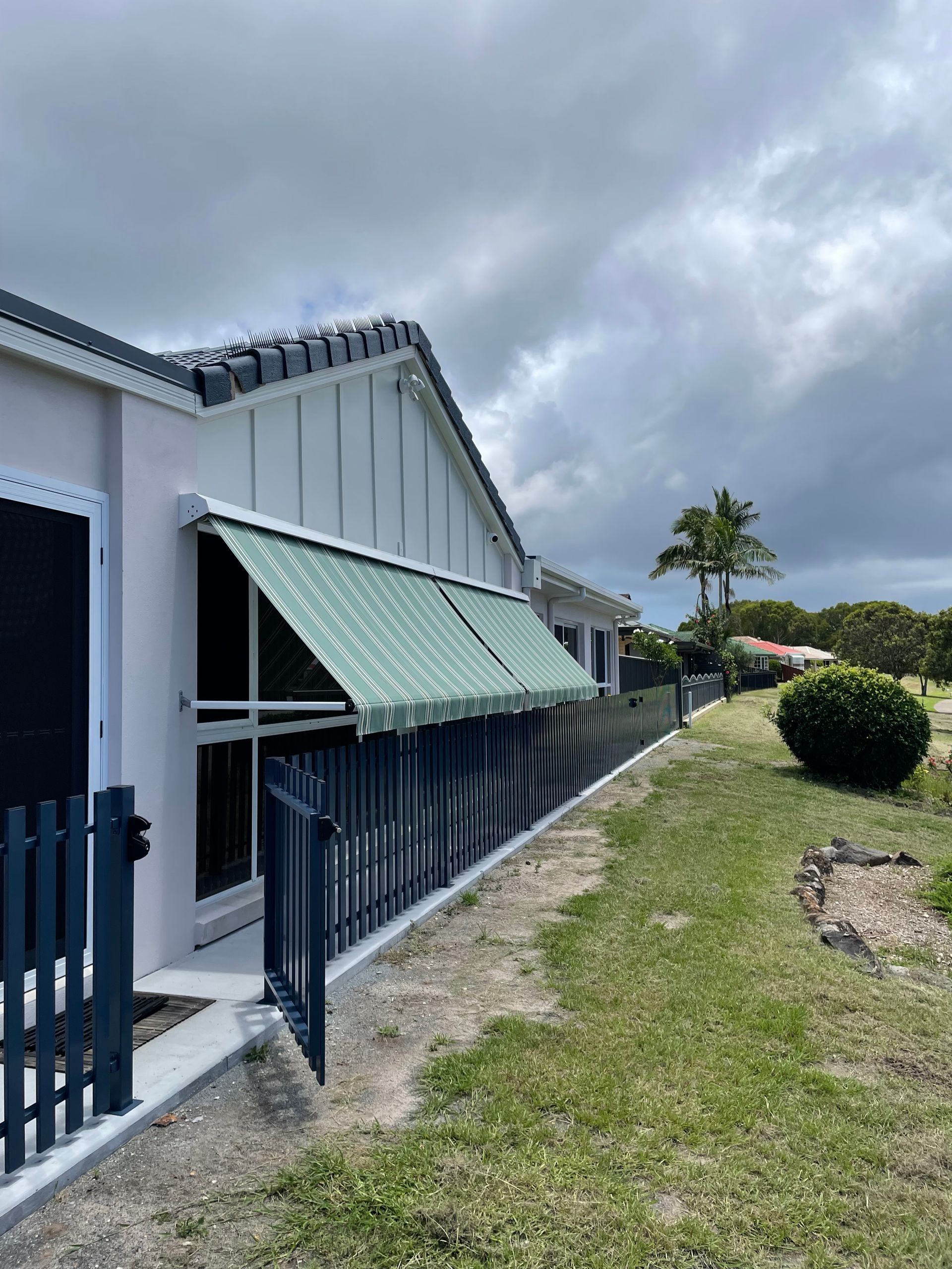 A Living Room With Hardwood Floors And White Furniture — Scott Graham Building Services In Bilambil Heights, NSW