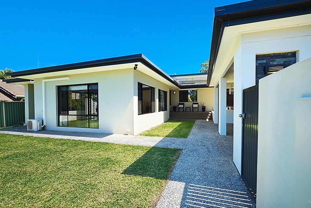 Modern White House With Black Trim, a Grassy Yard