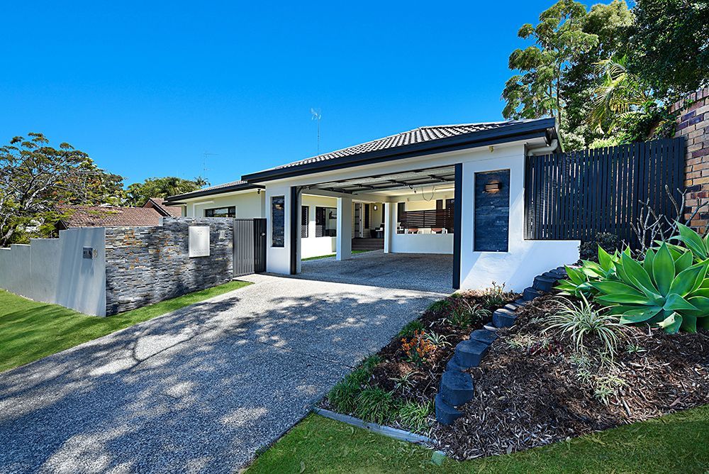 A White House With a Black Fence and a Driveway Leading to It  — Scott Graham Building Services In Bilambil Heights, NSW 