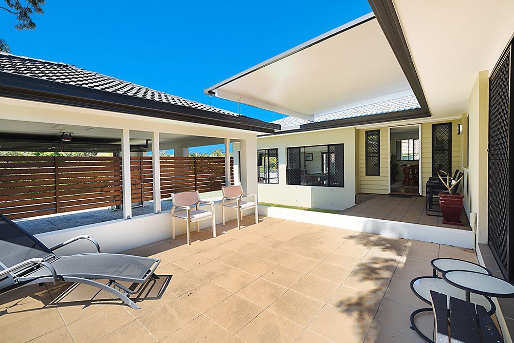 A Patio With Chairs and Tables in Front of a House  — Scott Graham Building Services In Bilambil Heights, NSW 