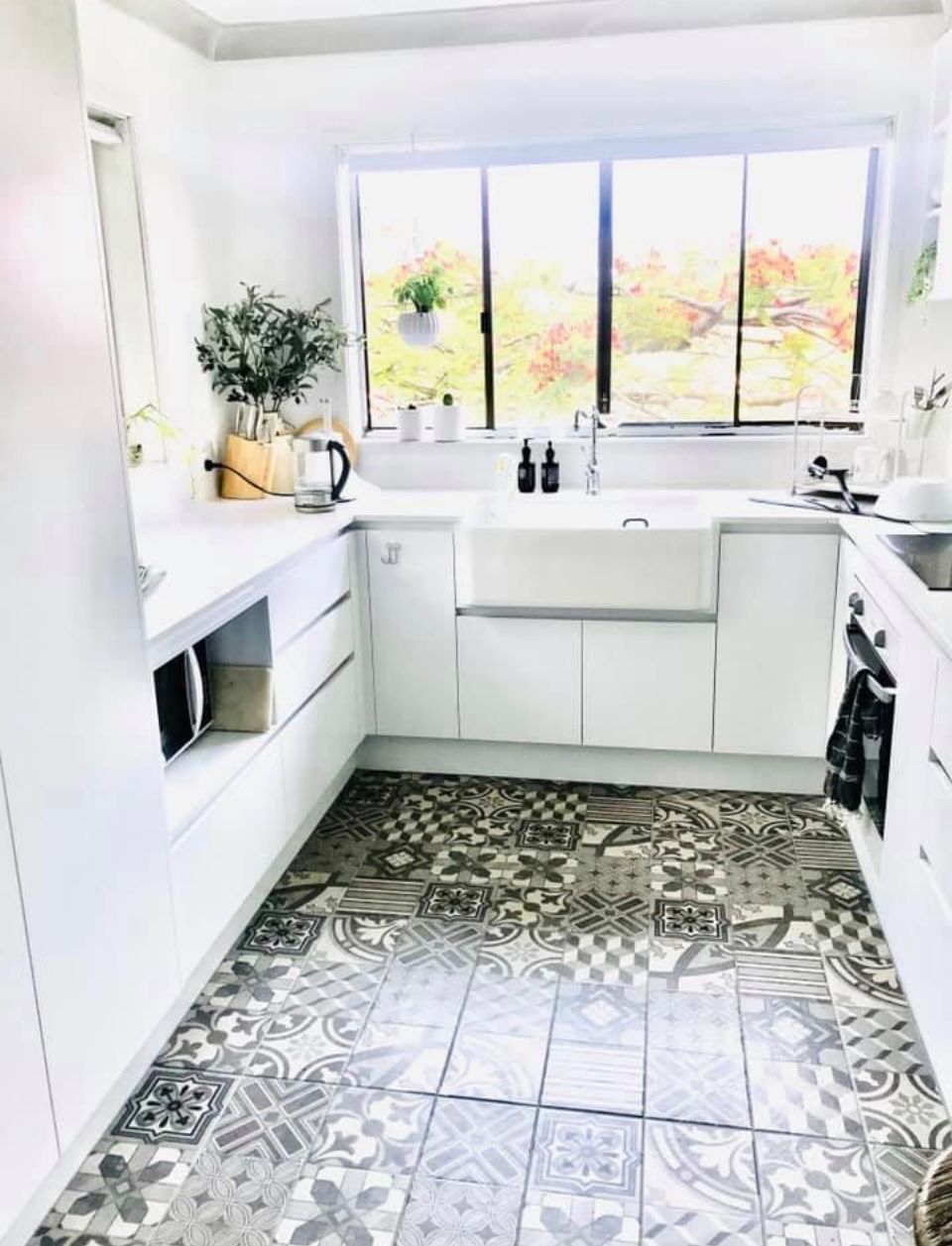 A Kitchen With White Cabinets , a Sink , and a Window  — Scott Graham Building Services In Bilambil Heights, NSW