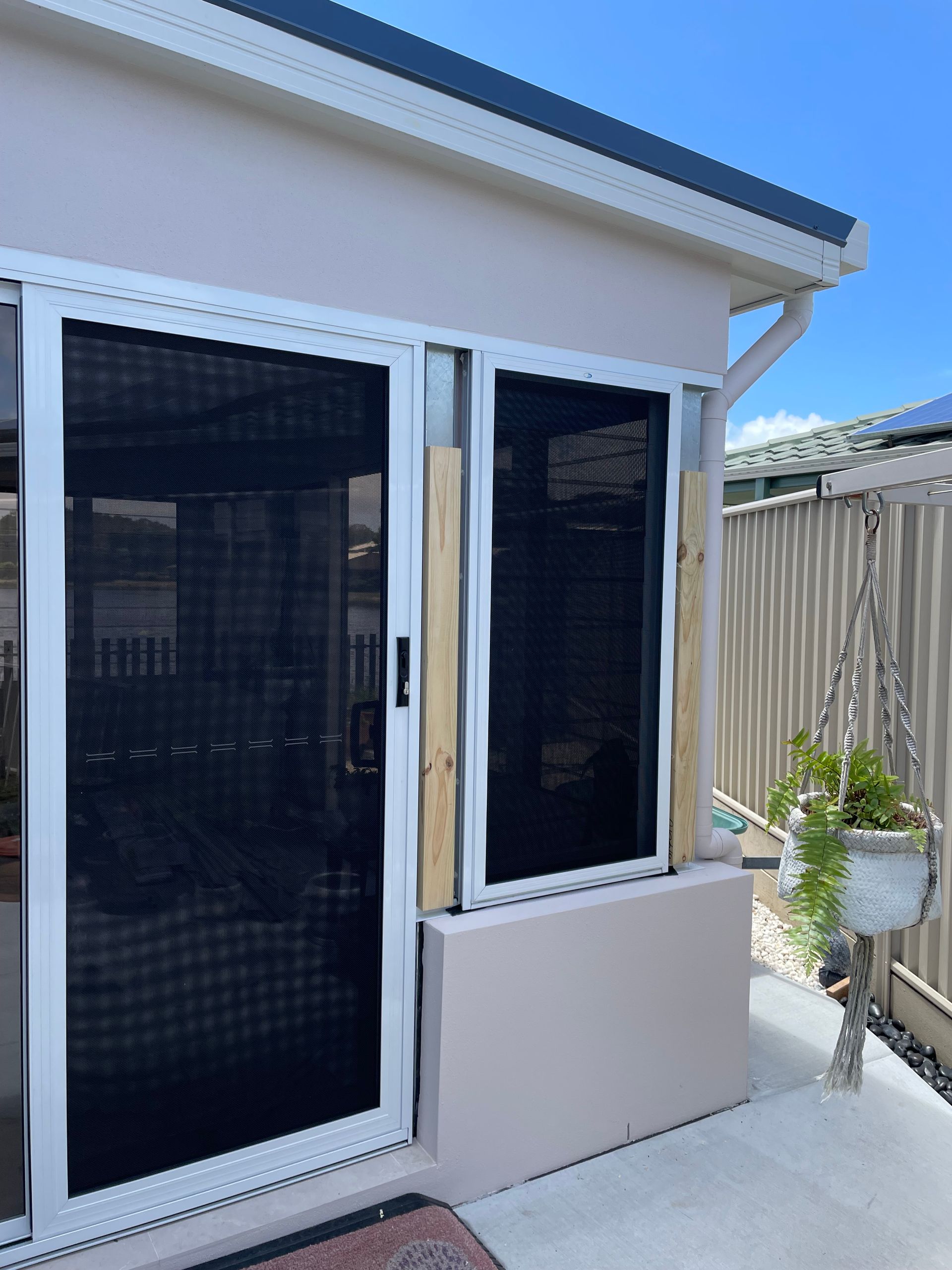 A House With a Sliding Glass Door and a Window  — Scott Graham Building Services In Bilambil Heights, NSW
