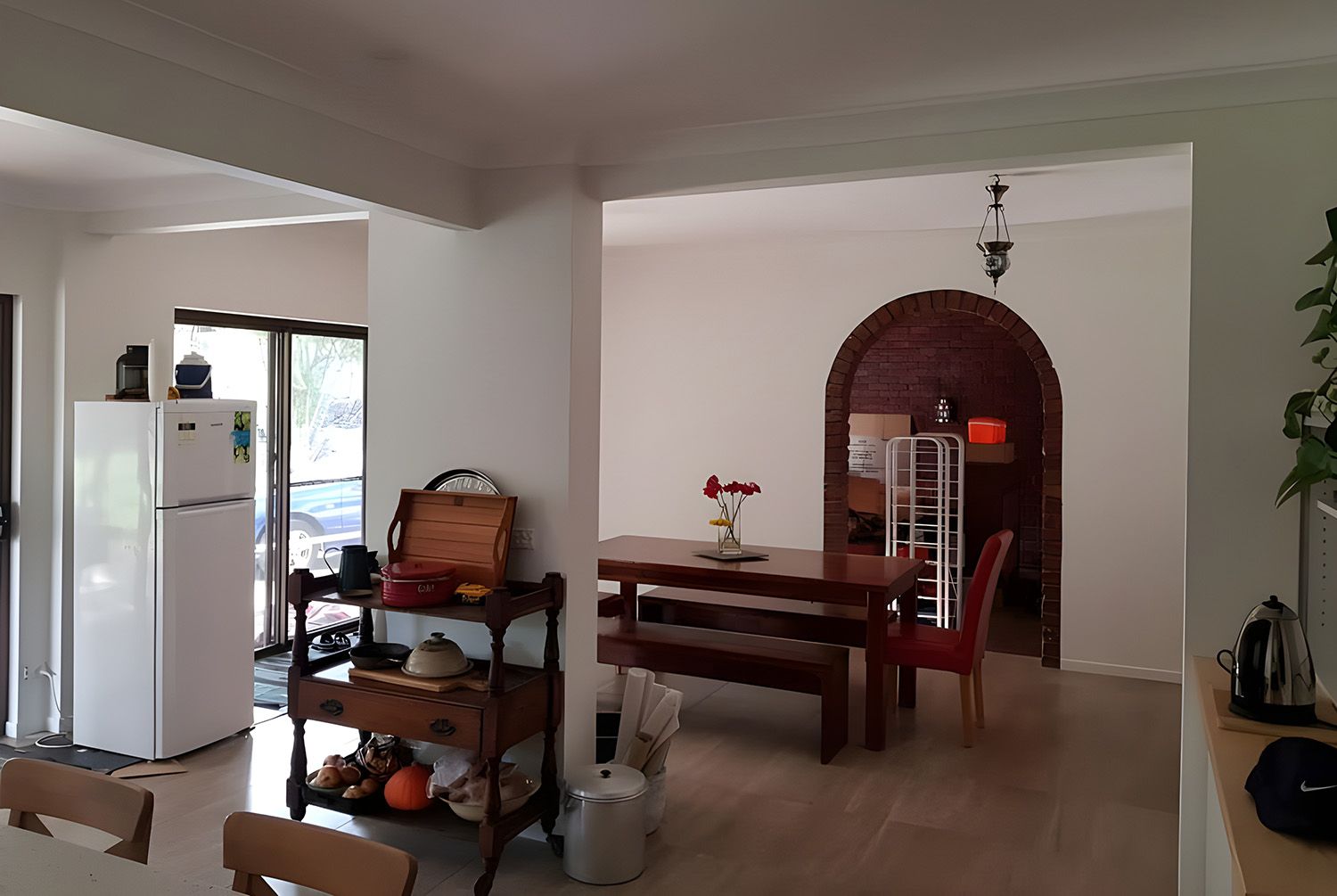 Kitchen And Dining Area With Archway To A Room