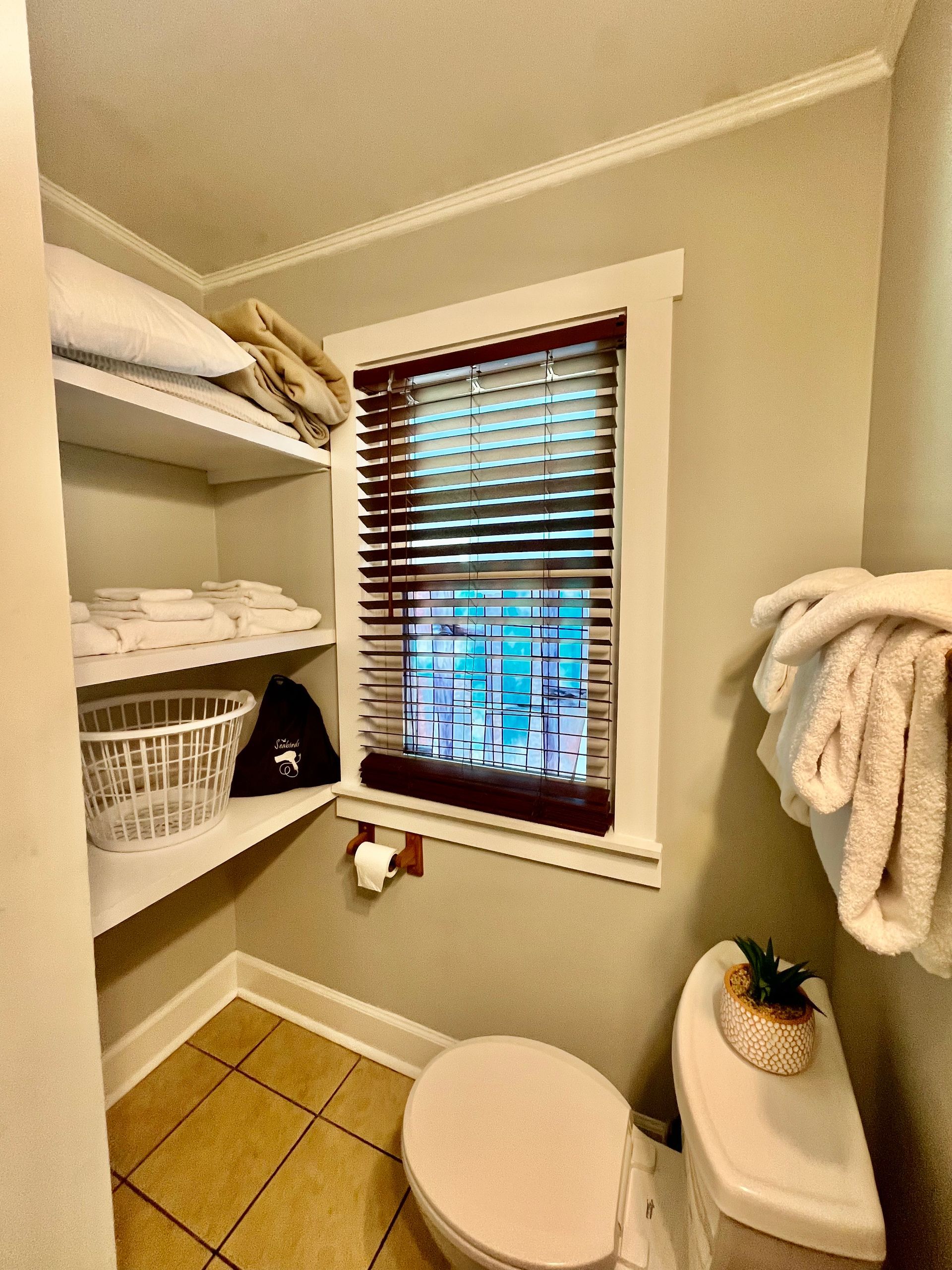A linen closet at Seabirds Motel at Kure Beach stocked with fresh towels and bedding, highlighting the motel’s commitment to providing a well-equipped and pet-friendly lodging experience in North Carolina.