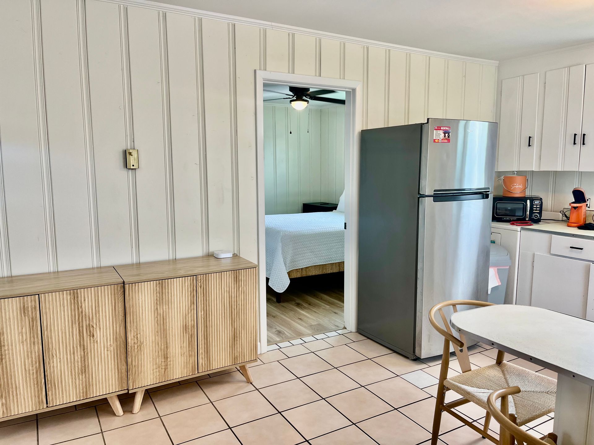 A modern kitchen at Seabirds Motel at Kure Beach equipped with a refrigerator, stove, and ample counter space. The kitchen is ideal for guests who enjoy cooking, providing a pet-friendly lodging option in North Carolina.