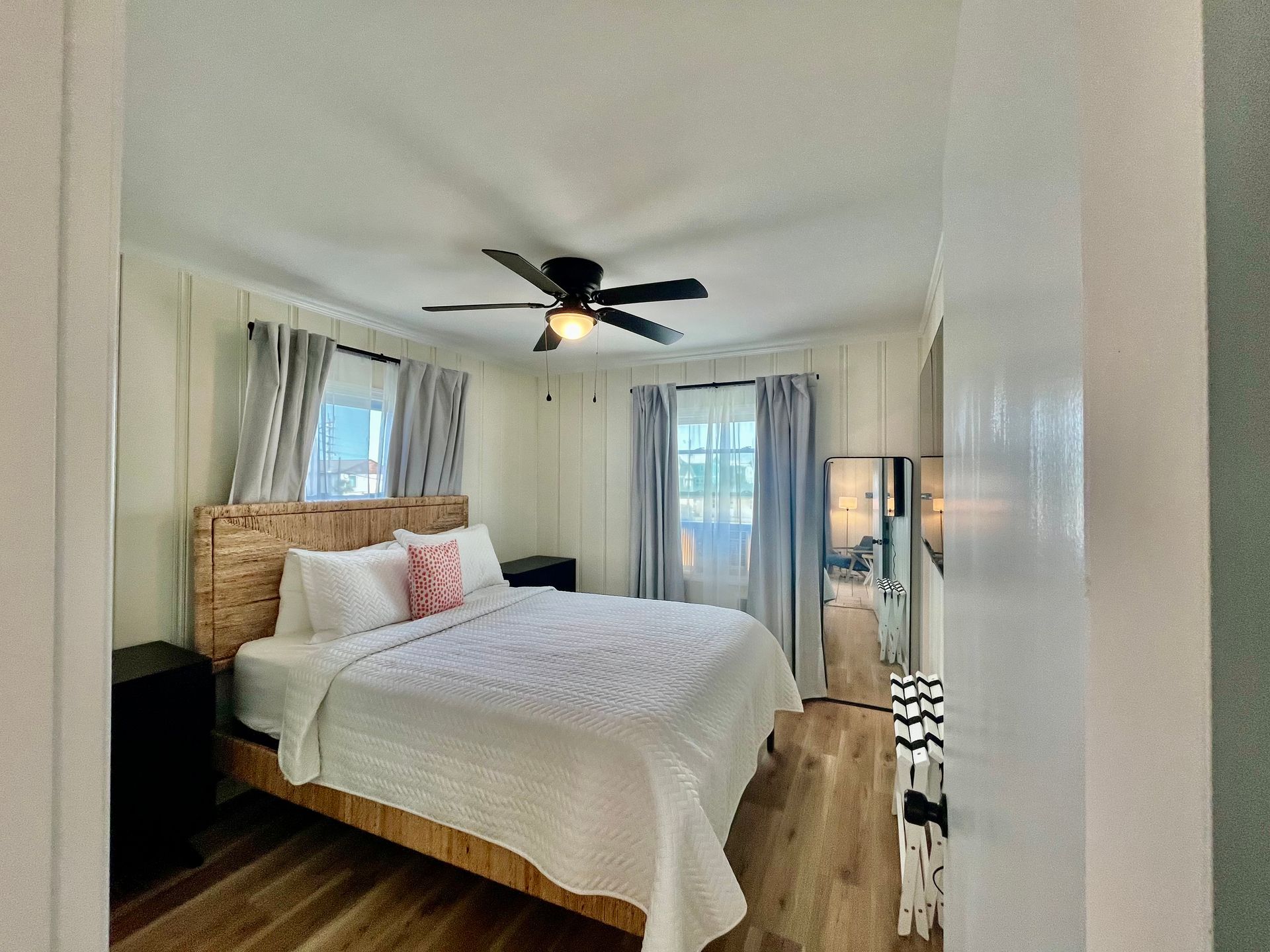 A comfortable bedroom at Seabirds Motel at Kure Beach with a queen-sized bed, white linens, and soft lighting. The room is designed for relaxation, making it perfect for a pet-friendly stay in North Carolina.