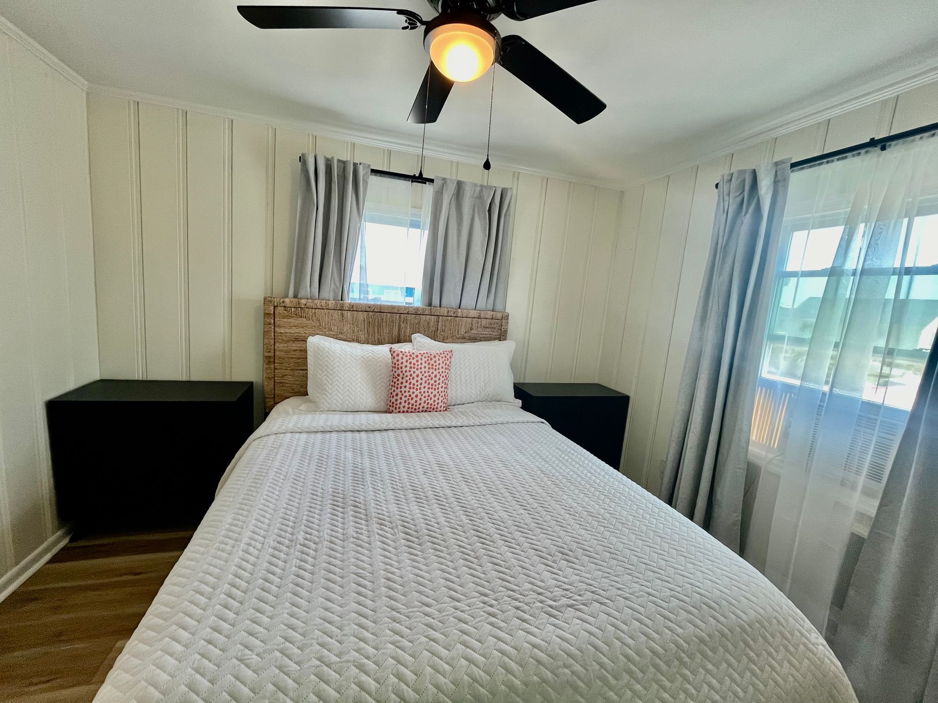 A bright guest room at Seabirds Motel at Kure Beach featuring a queen-sized bed, coastal-themed decor, and ample natural light. The room offers a serene setting for a pet-friendly stay in North Carolina.
