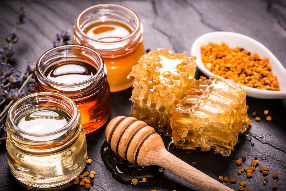 Honey in jar with honey dipper — Holistic Health in Hervey Bay QLD