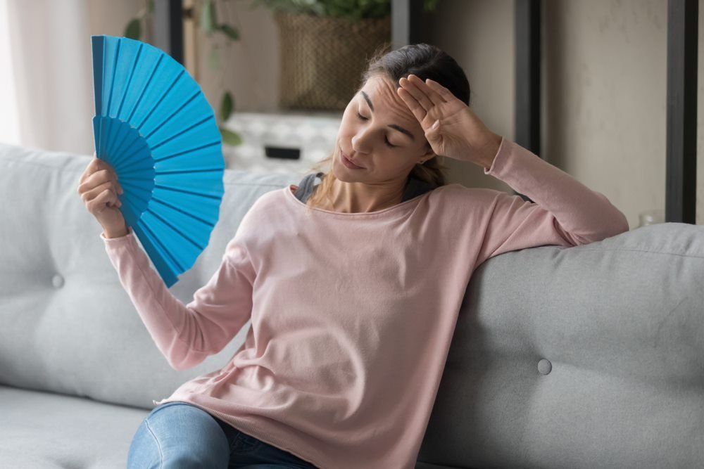 Lady with Fan Suffering From Hormonal Imbalance — Hormonal Imbalances in Hervey Bay QLD