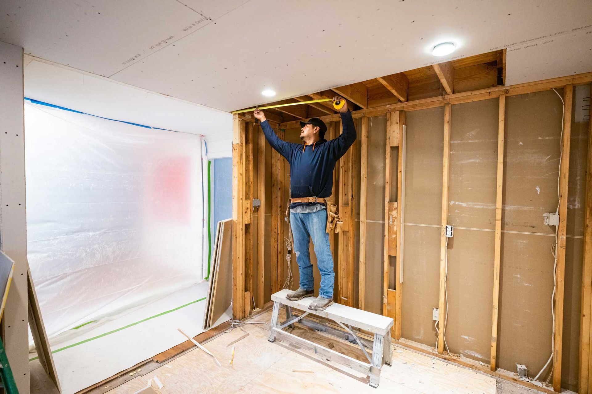 Drywall installers working in kitchen renovation. Drywall installers working in kitchen renovation.