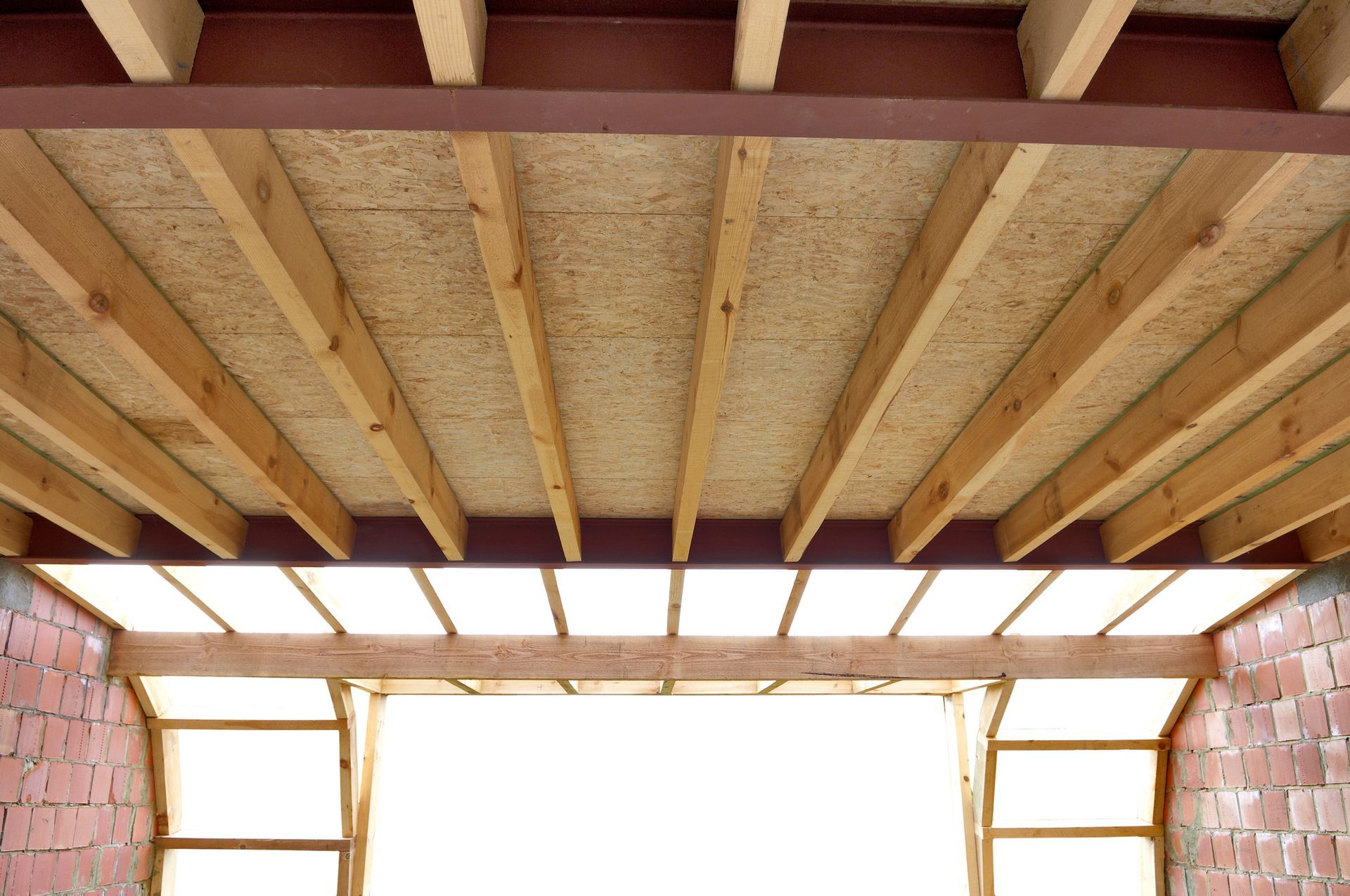 Interior roof view showcasing ceiling insulation being installed for improved home comfort.
