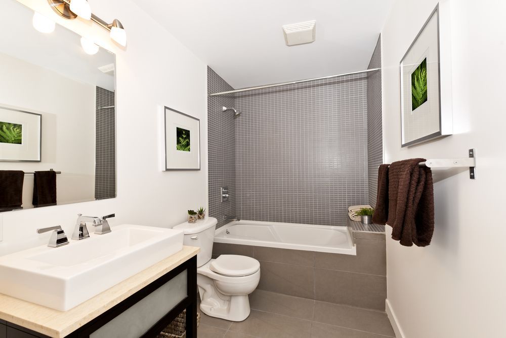 A Bathroom With A Sink, Toilet, Bathtub And Mirror — Damn Fine Constructions In Coffs Harbour, NSW