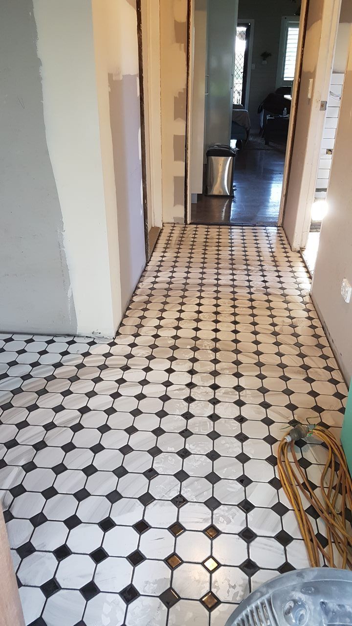 A Hallway With A Black And White Checkered Tile Floor — Damn Fine Constructions In Bonville, NSW