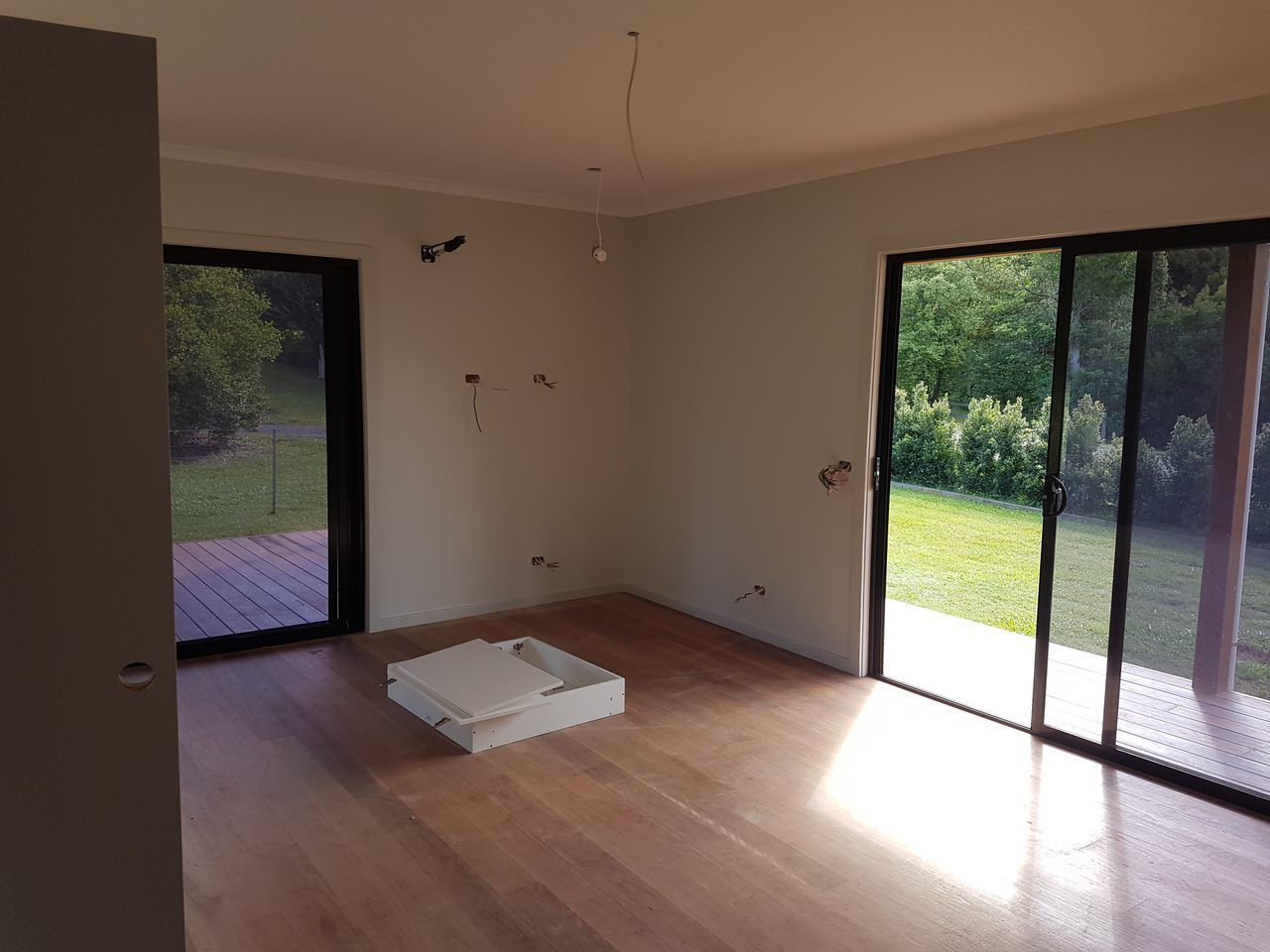 A Man Is Sitting On A Bathtub While Installing Tiles — Damn Fine Constructions In Bonville, NSW
