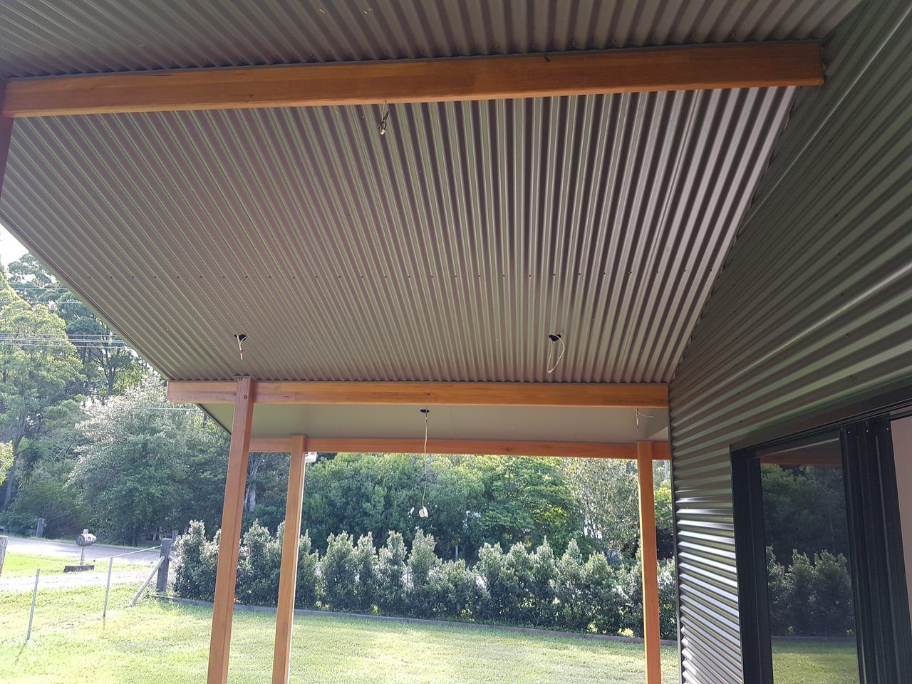 A Man And A Woman Are Cutting A Piece Of Wood On A Table Saw — Damn Fine Constructions In Bonville, NSW