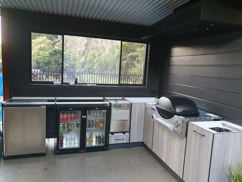 A Kitchen With A Grill, Refrigerator, Sink And Window — Damn Fine Constructions In Bellingen, NSW