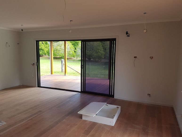 An Empty Room With A Sliding Glass Door — Damn Fine Constructions In Bonville, NSW