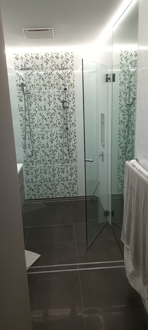 A Bathroom With A Walk In Shower And A Towel Rack — Damn Fine Constructions In Coffs Harbour, NSW
