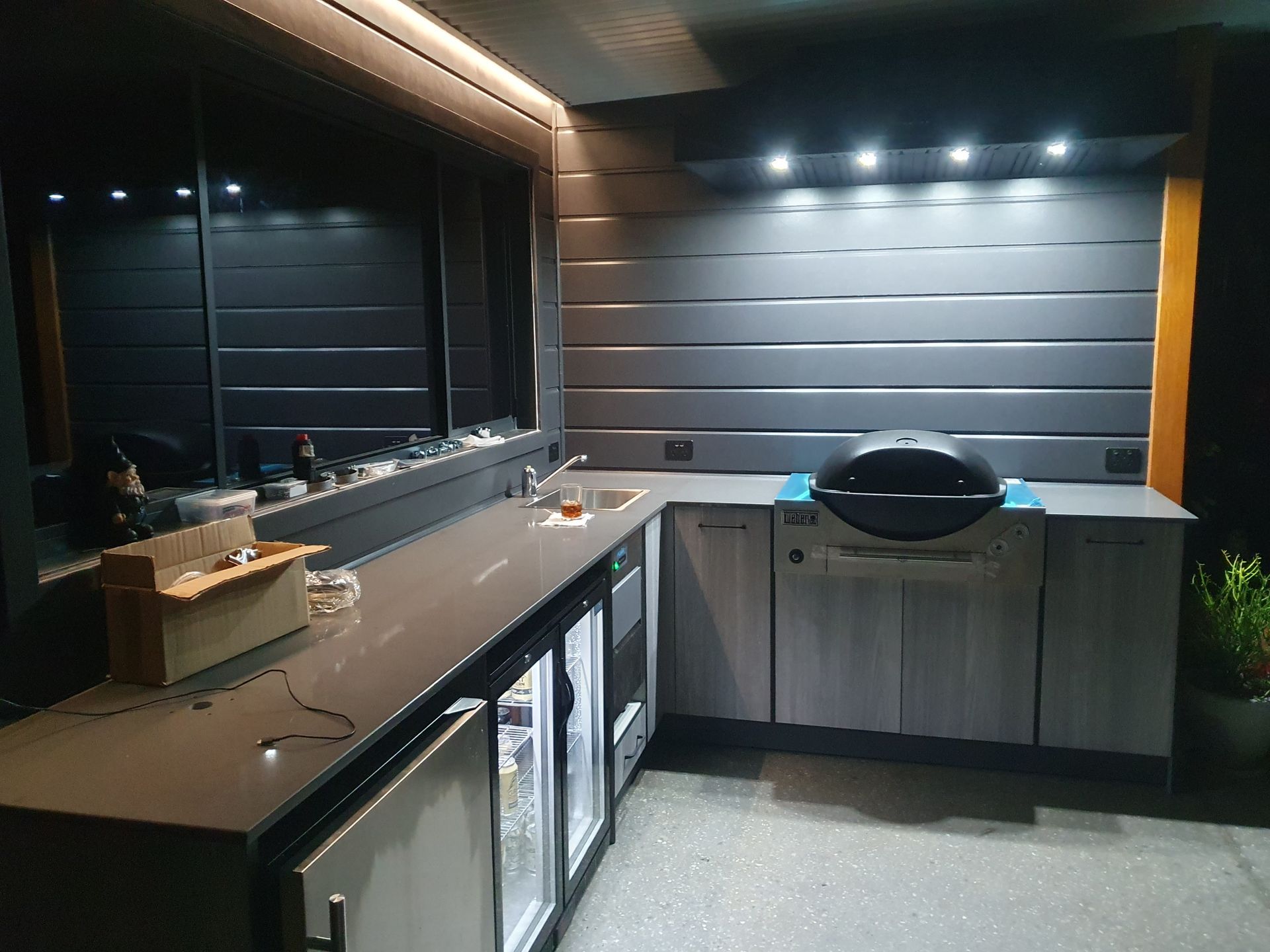 A Man Is Sanding A Piece Of Wood With A Sander — Damn Fine Constructions In Bonville, NSW