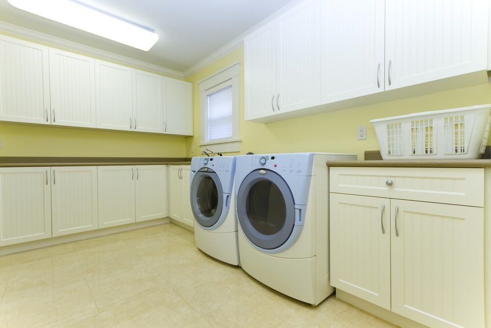 A Laundry Room With Two Washers And Two Dryers — Damn Fine Constructions In Bonville, NSW