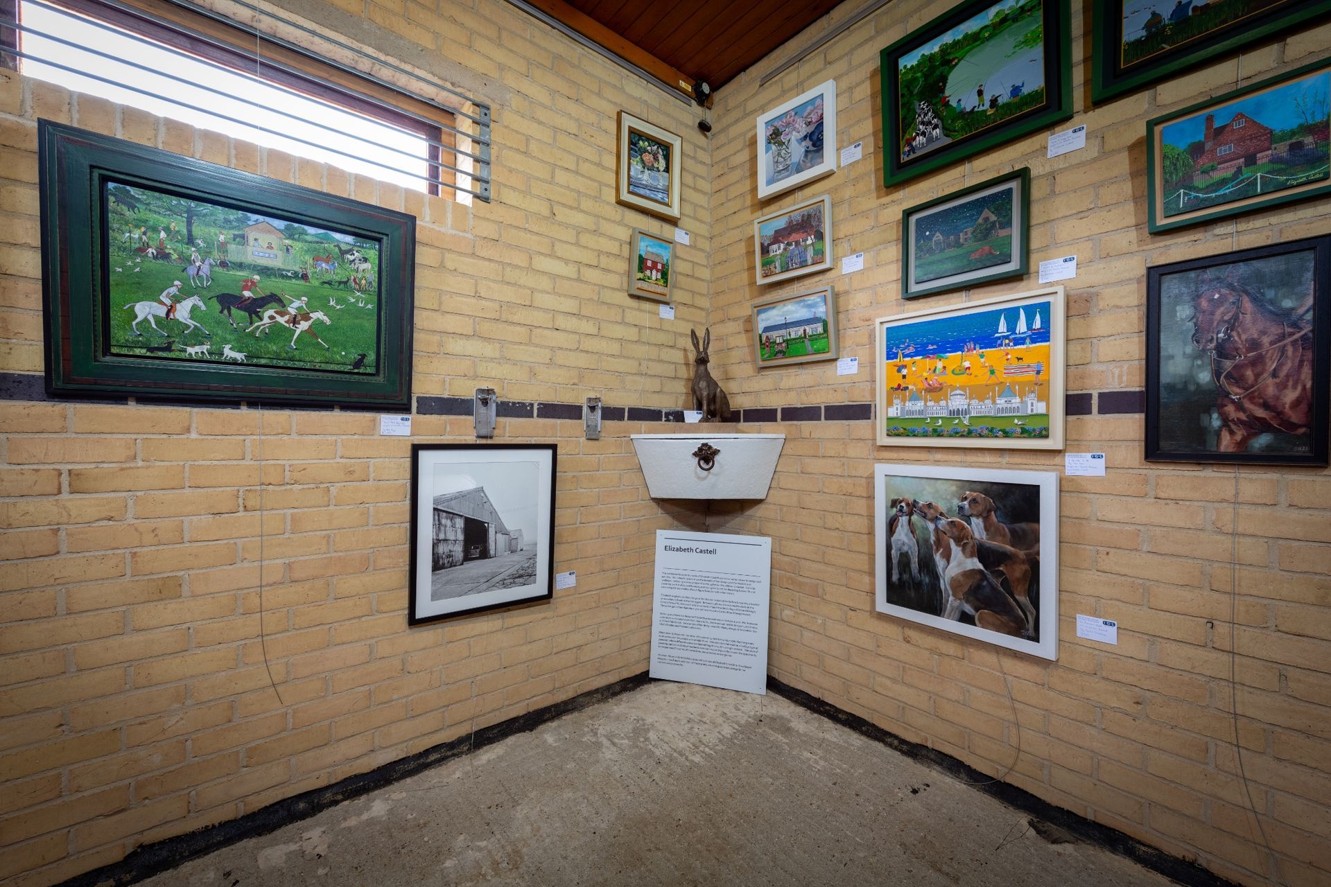 A room with a lot of paintings on the wall.