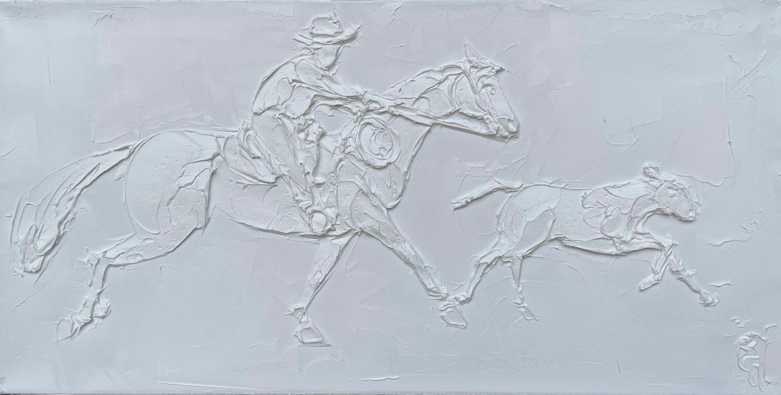 Relief sculpture of cowboy on horseback, with a dog running alongside. White textured surface.