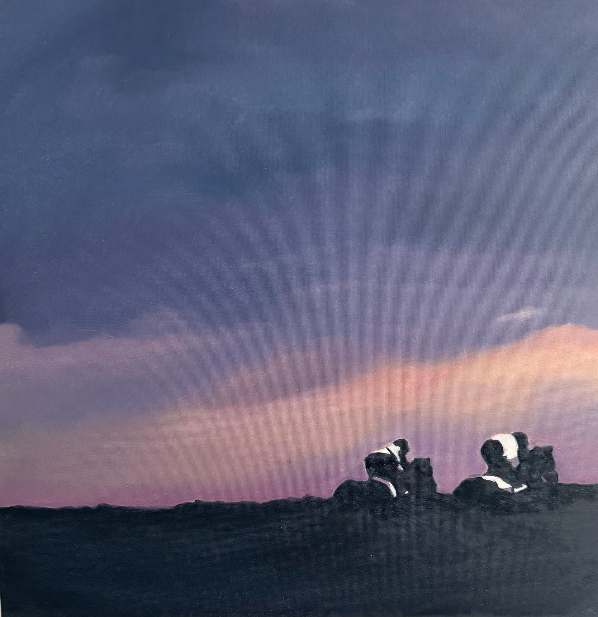 Purple and pink sunset over a dark landscape with two small white and black shapes.