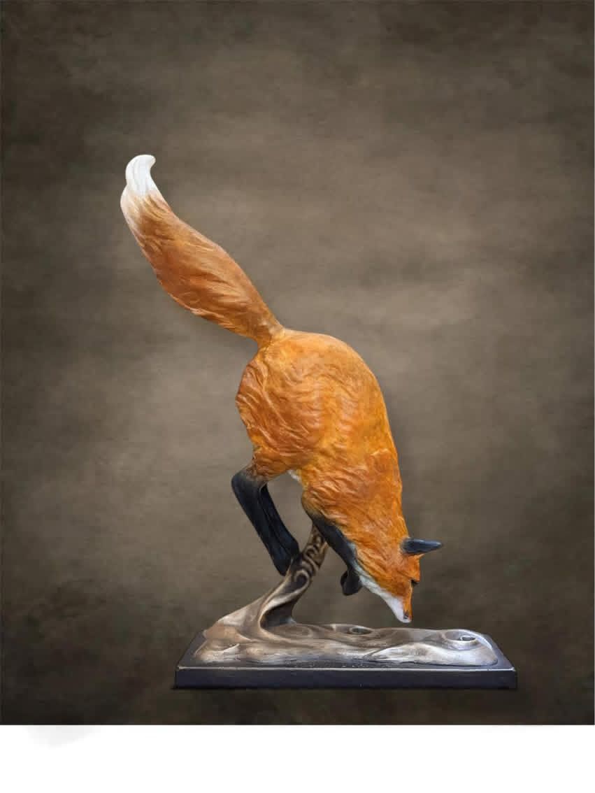 Bronze fox sculpture reaching down, tail arched. Orange fur, gray base, against a brown backdrop.