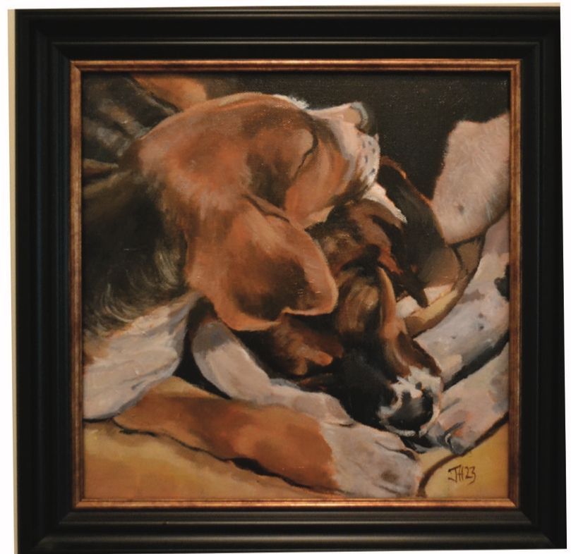 a framed painting of two dogs sleeping