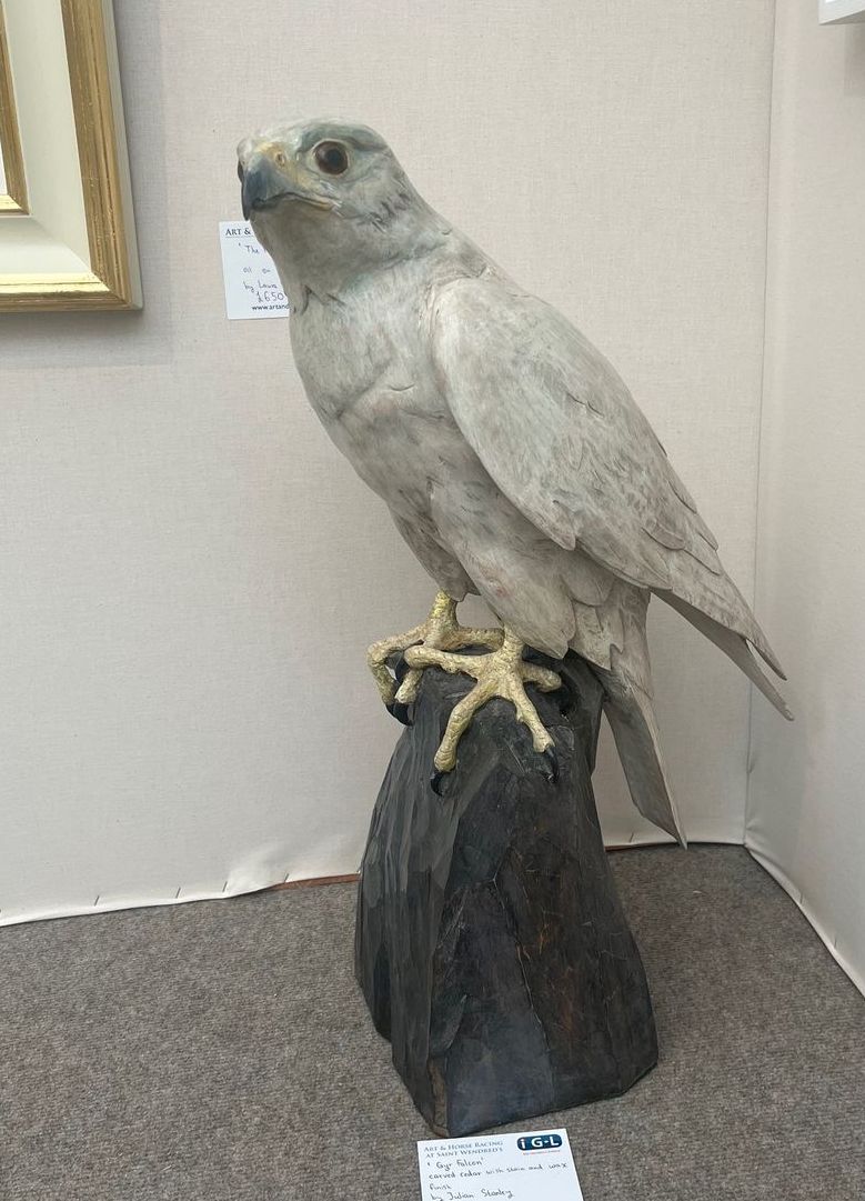 A statue of a bird sitting on top of a rock.