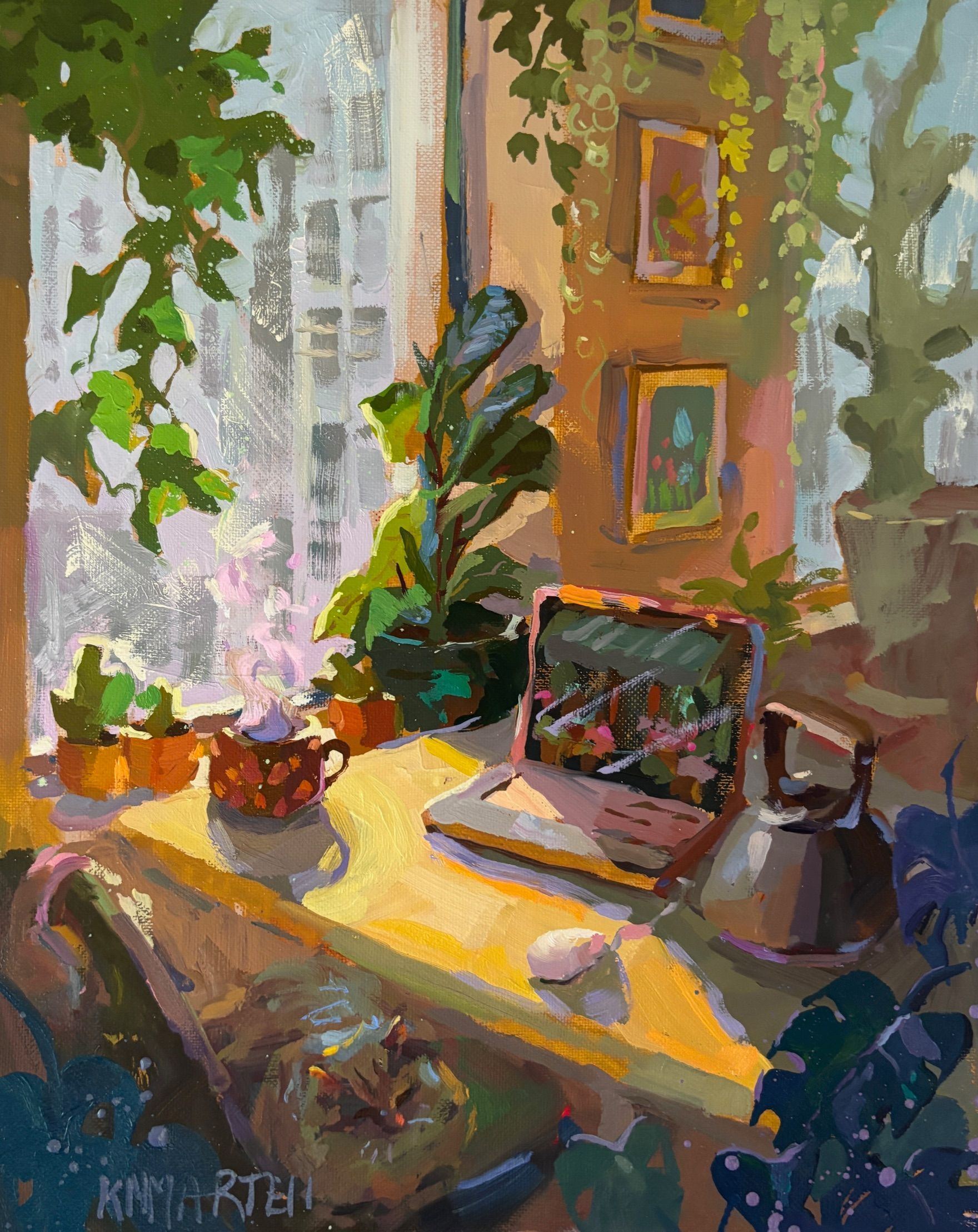Cozy sunlit workspace with laptop, plants, and teapot by a window.