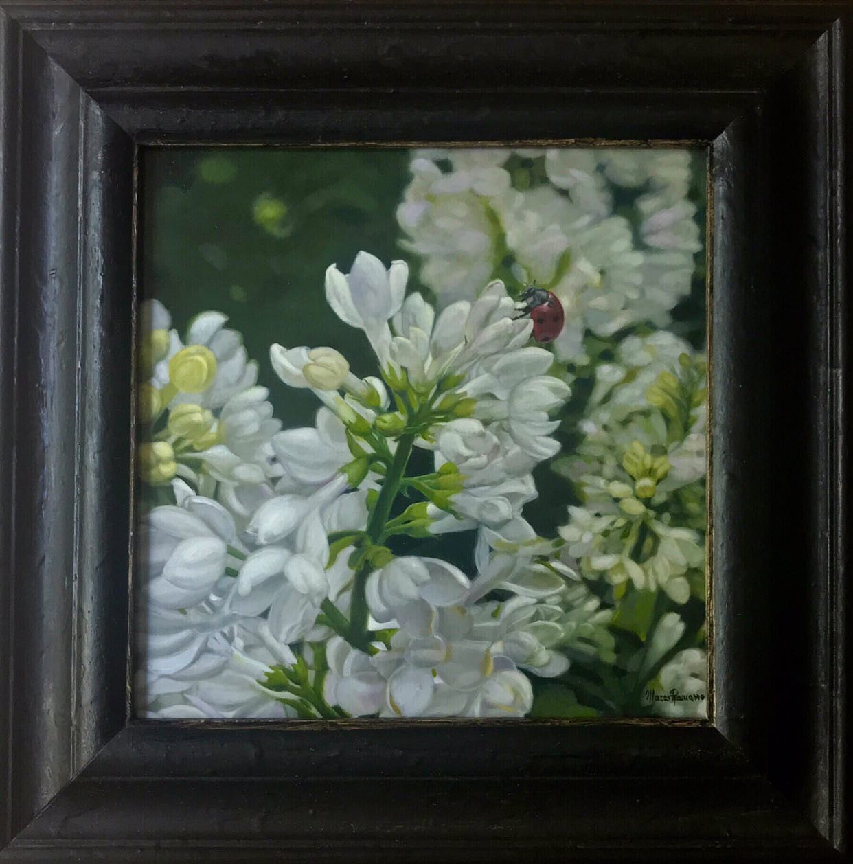 A ladybug is sitting on a white flower in a framed picture