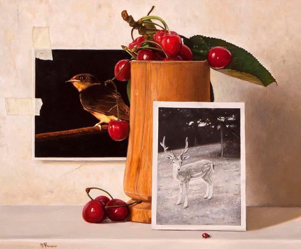 A painting of cherries and a picture of a deer