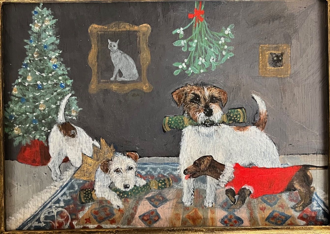 Jack Russell terriers in a decorated room with a Christmas tree, art of a cat, and mistletoe.