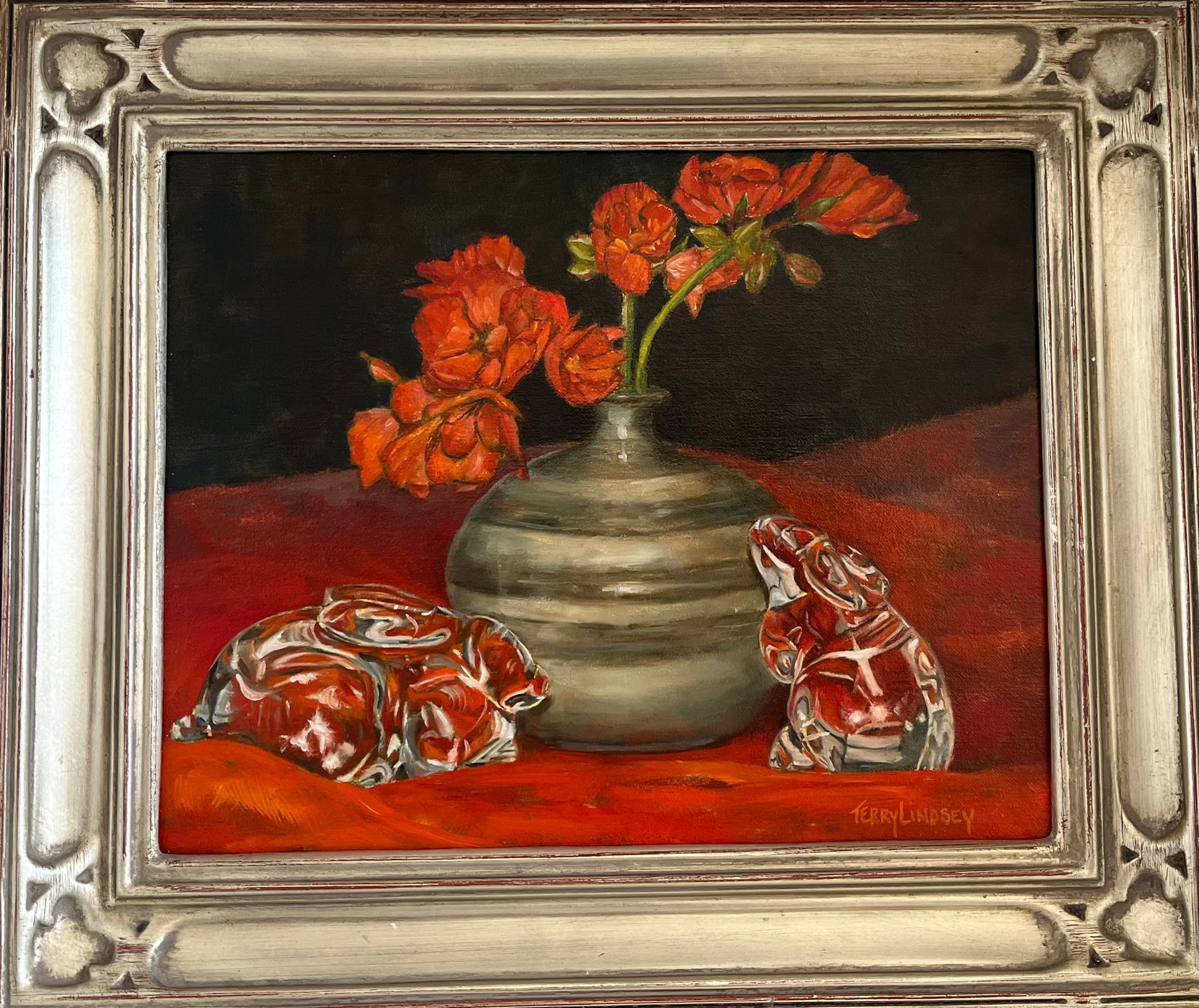 A framed painting of flowers in a vase with bunnies