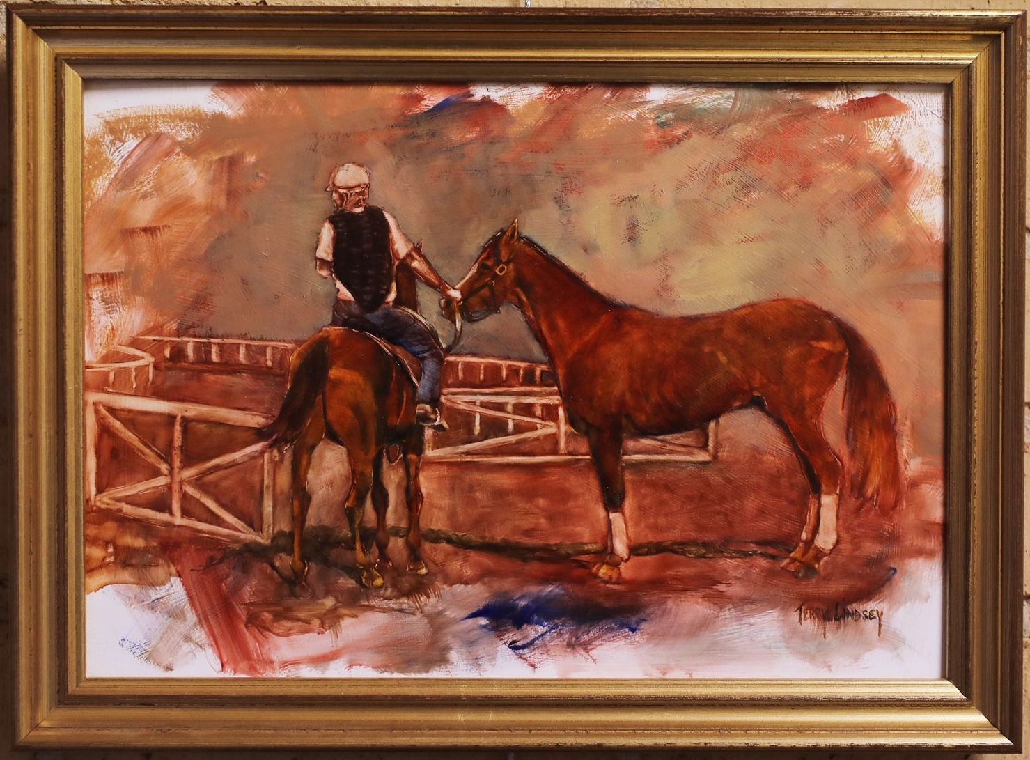 a framed painting of a man riding a brown horse leading a horse with no saddle