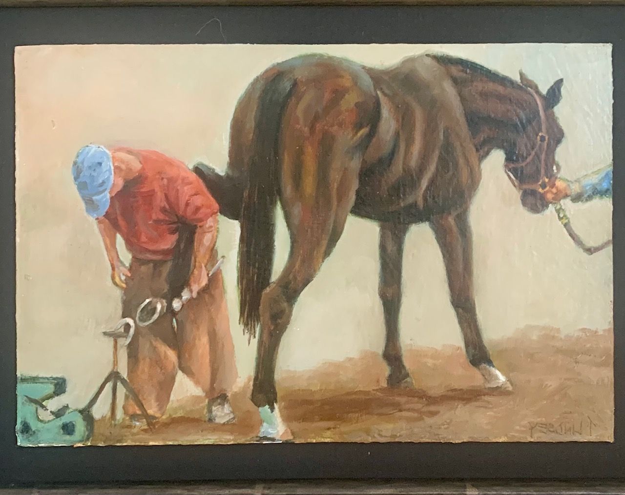 a framed painting of a farrier  shoeing a horse's hind hoof