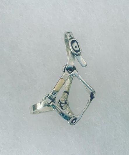 A close up of a silver ring on a white surface