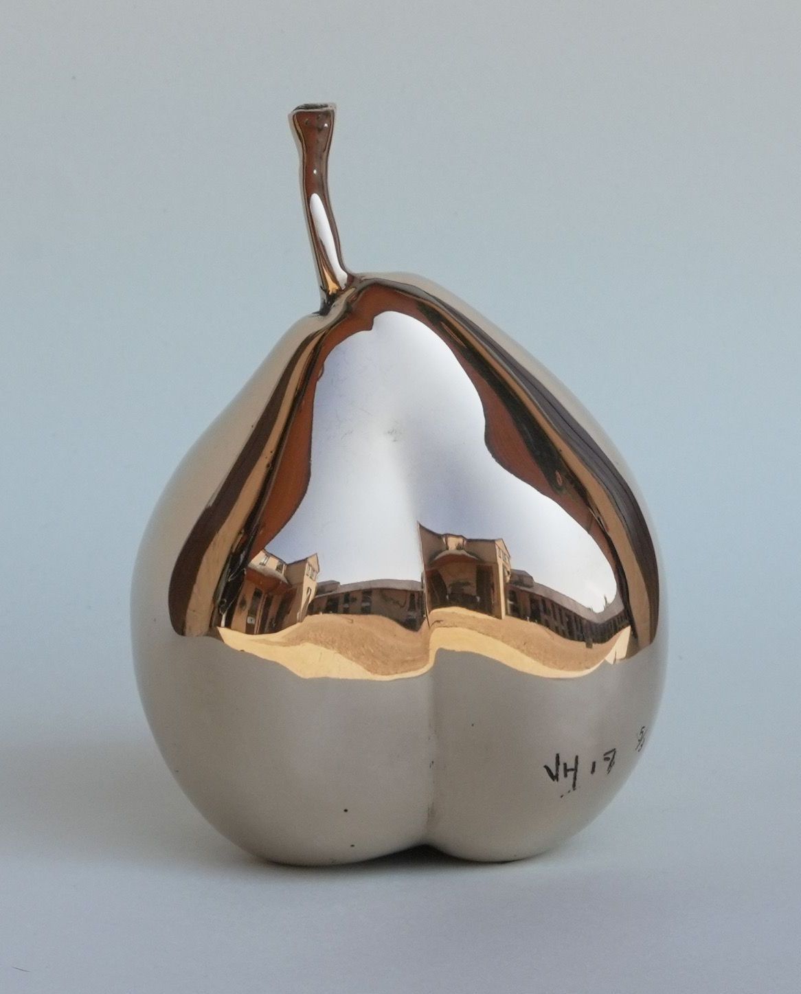 A silver sculpture of a pear with the year 2014 on it
