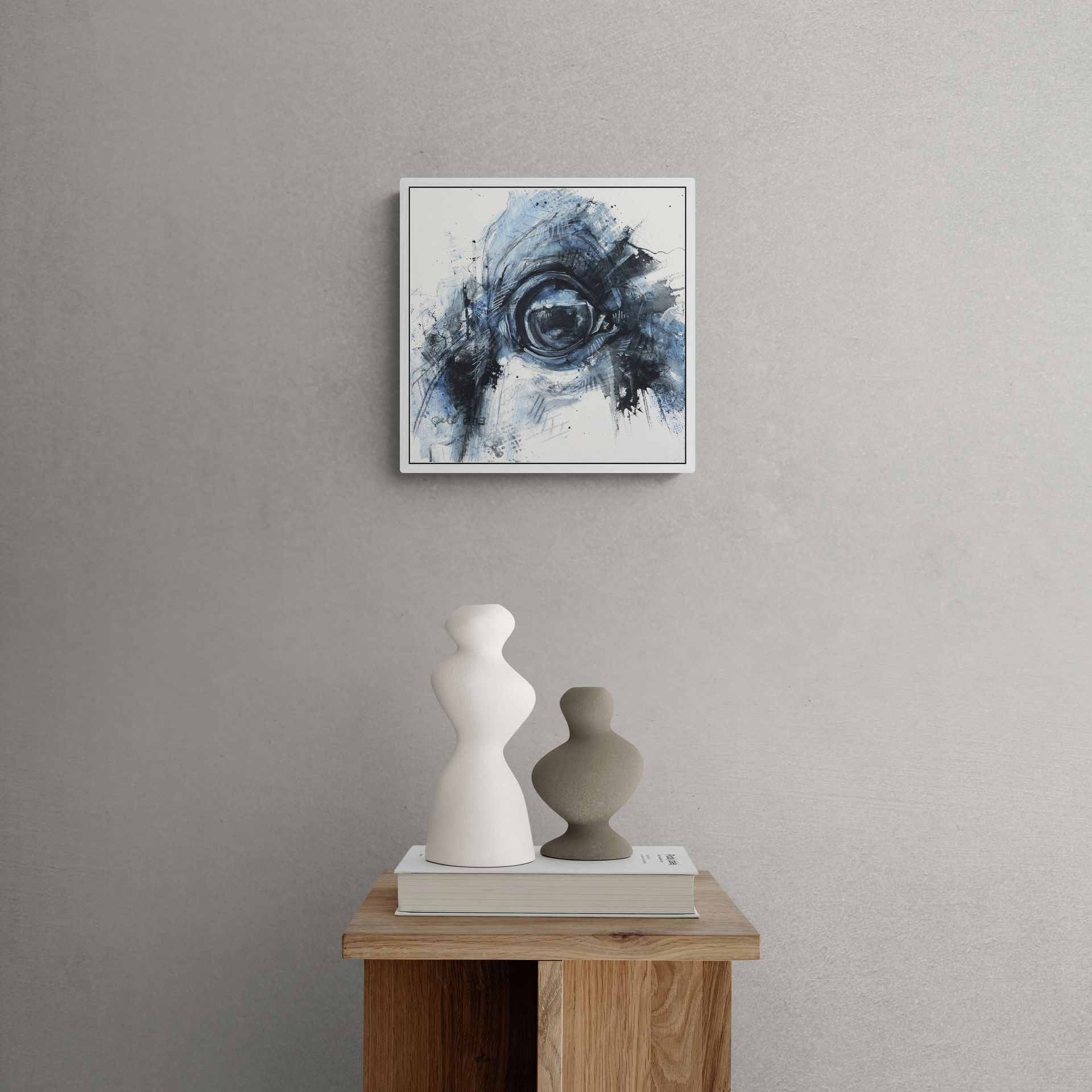 A painting is hanging on a wall above a wooden table