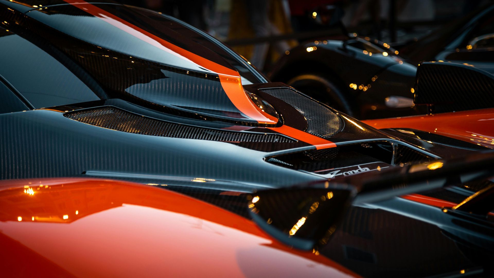 Red and black sports car with orange stripe detail.