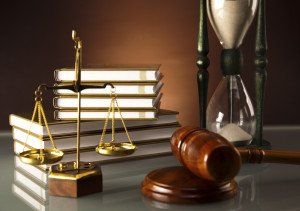 justice scales, a gavel, law books, and an hourglass