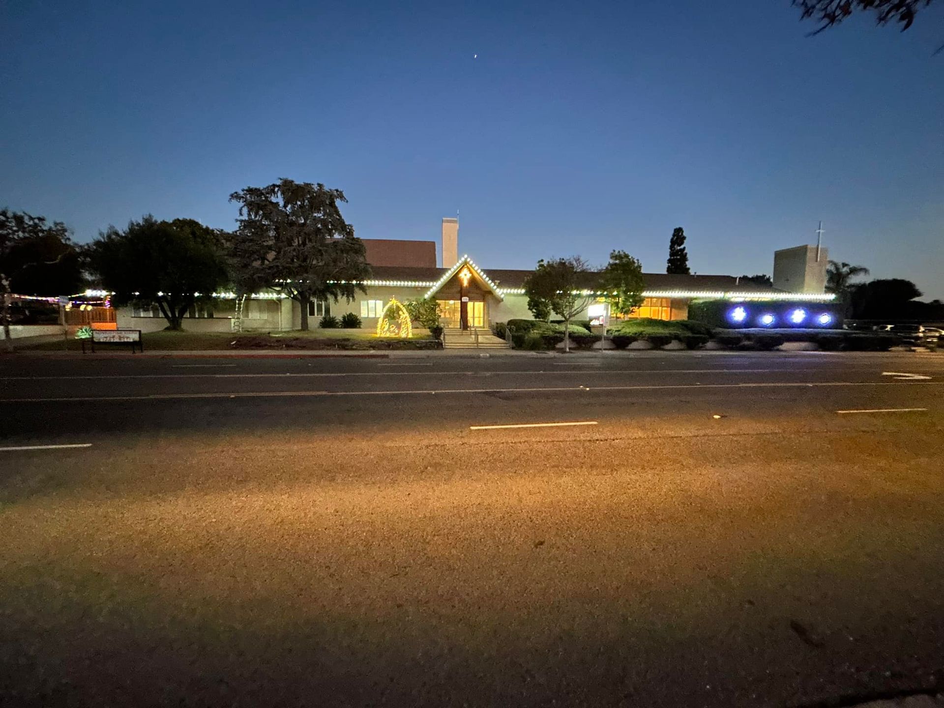 A large white house is lit up at night