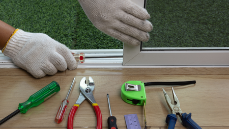 A person is cleaning a window with a squeegee.