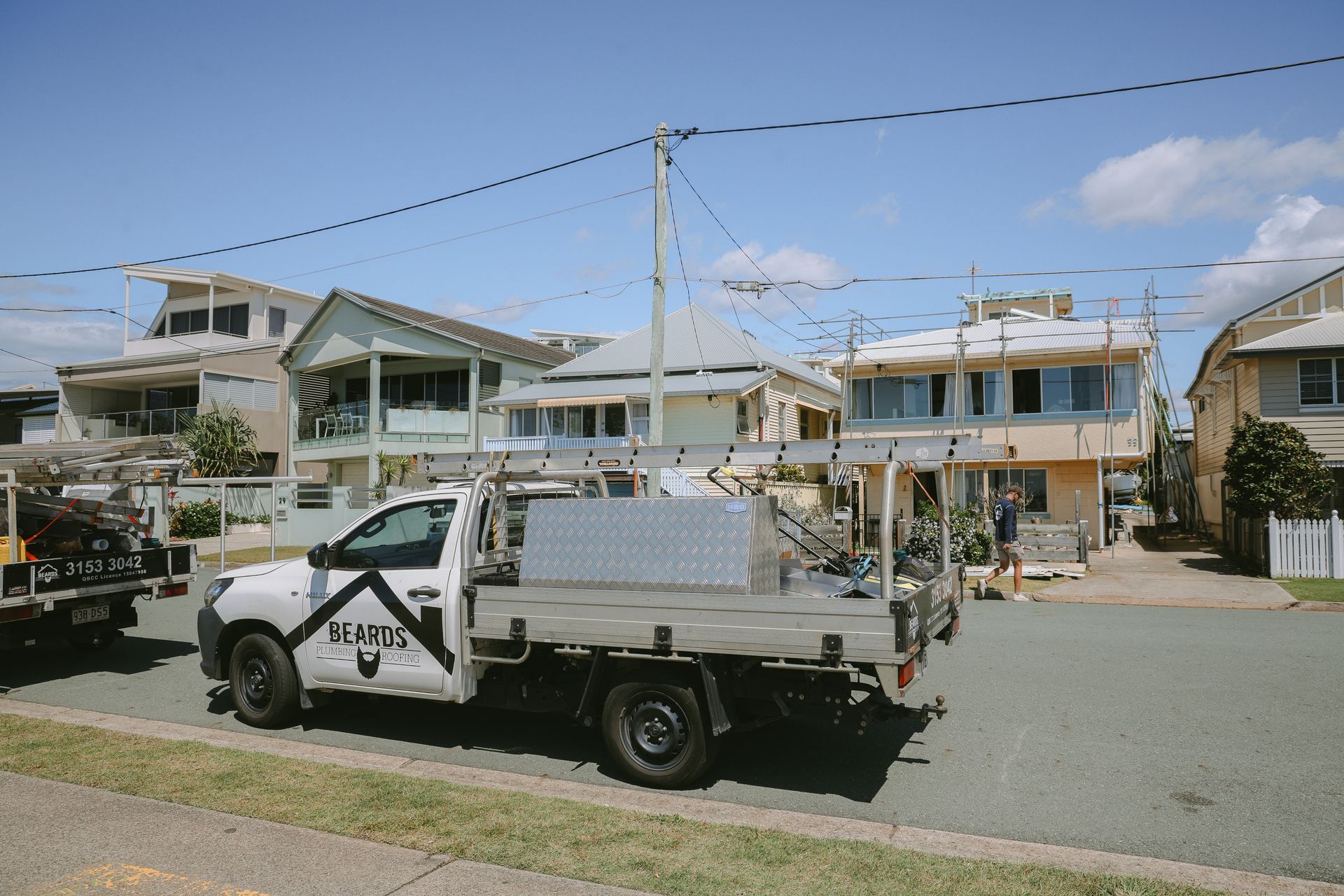A Work Ute Out The Front Of A House Having The Roof Replaced — Beards Roofing and Plumbing in Kallangur, QLD