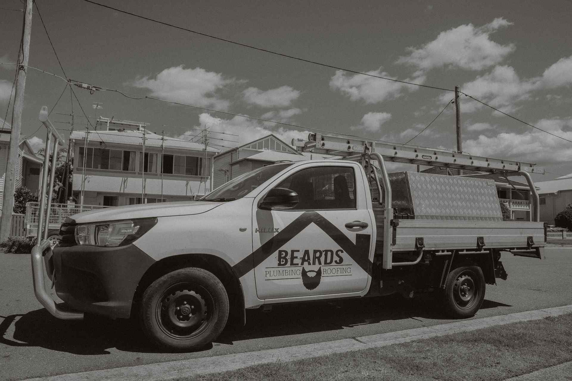 Black and White Photo of a Truck Parked — Beards Roofing and Plumbing in Clontarf, QLD
