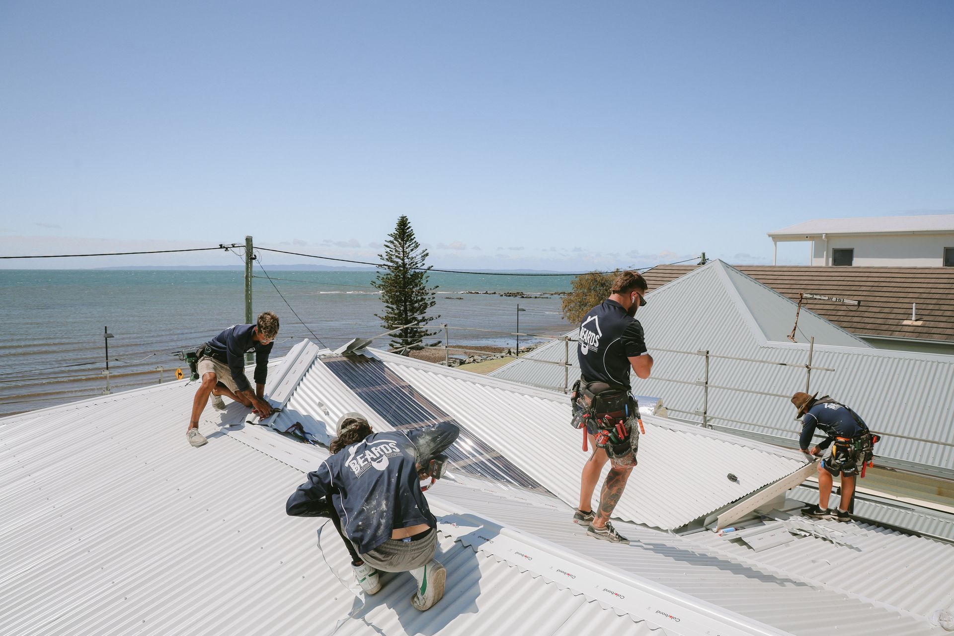 Four Men Installing A New Roof — Beards Roofing and Plumbing in Morayfield, QLD